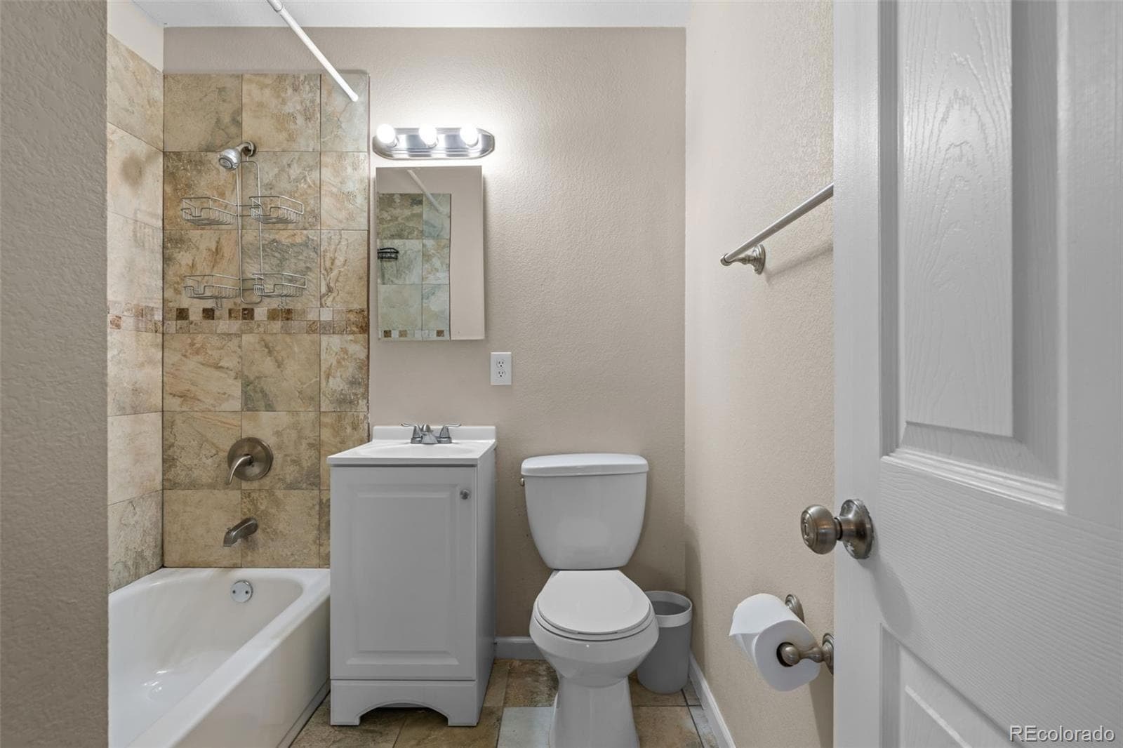 A full bathroom with a tiled shower and tub