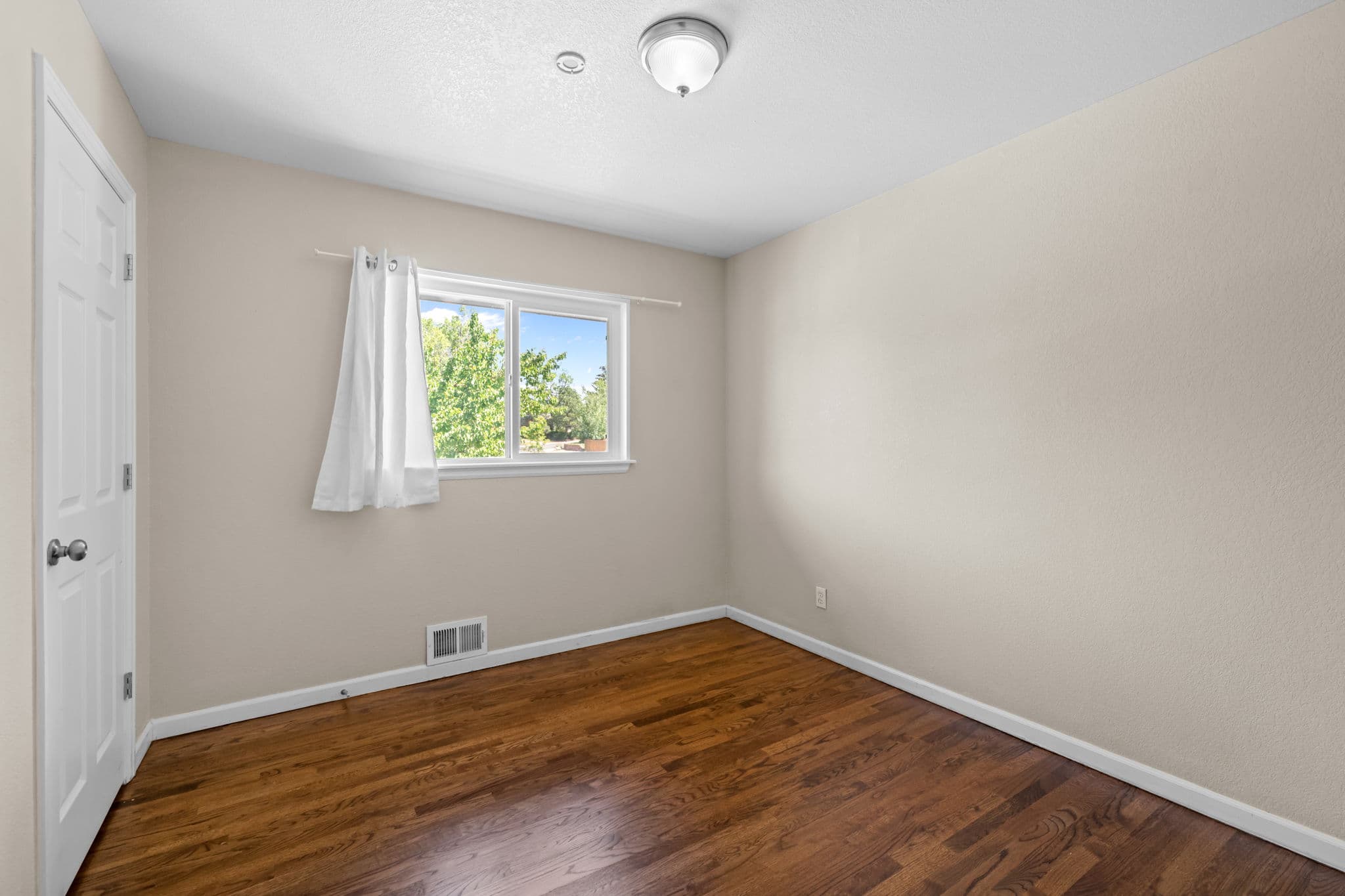 A private bedroom with a closet and a west-facing window