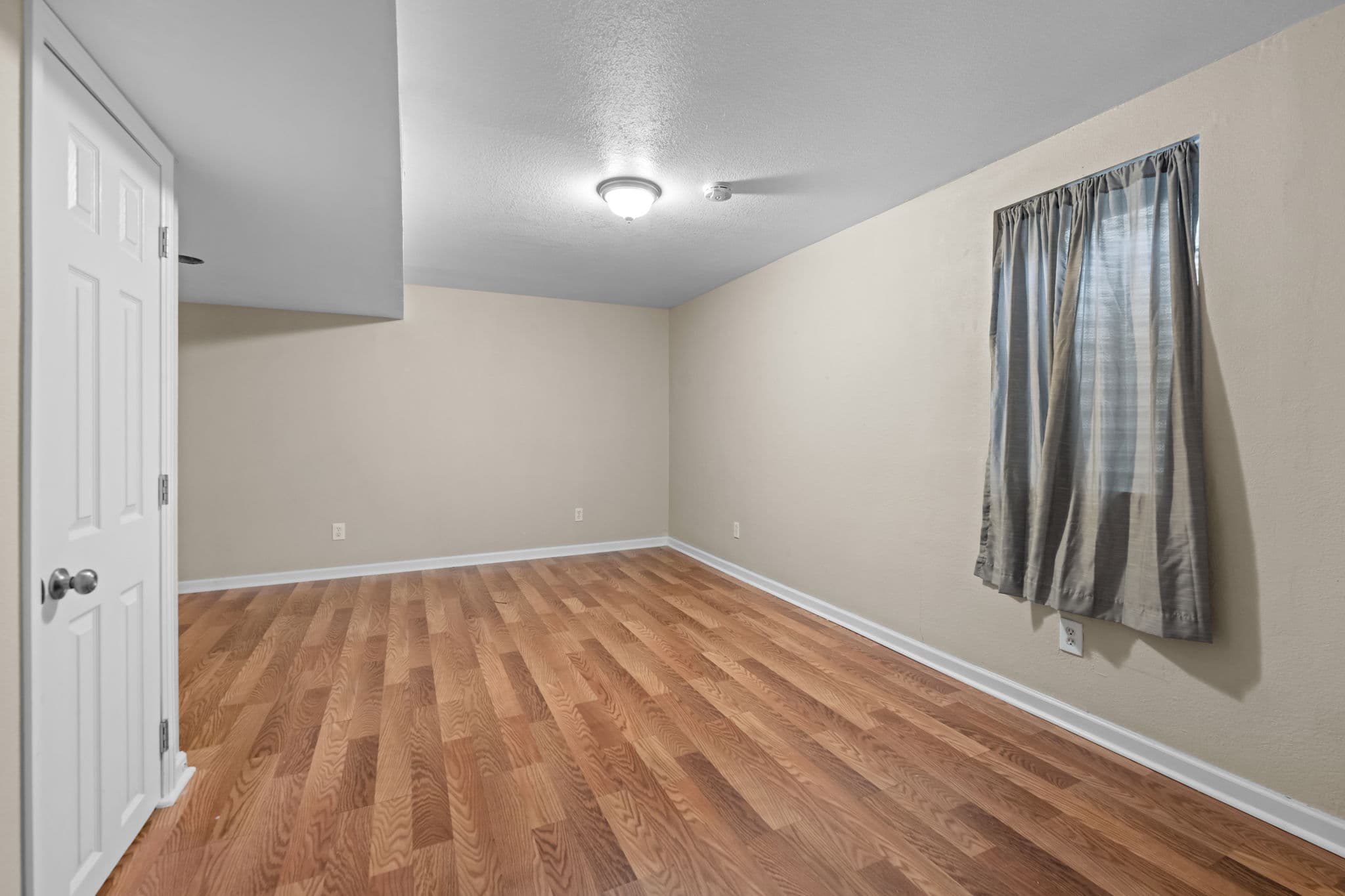 A lower-level bedroom with a closet