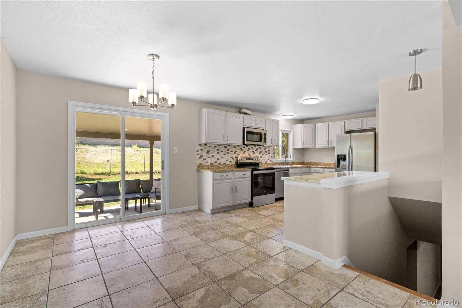 The shared kitchen and dining area, opening onto the patio