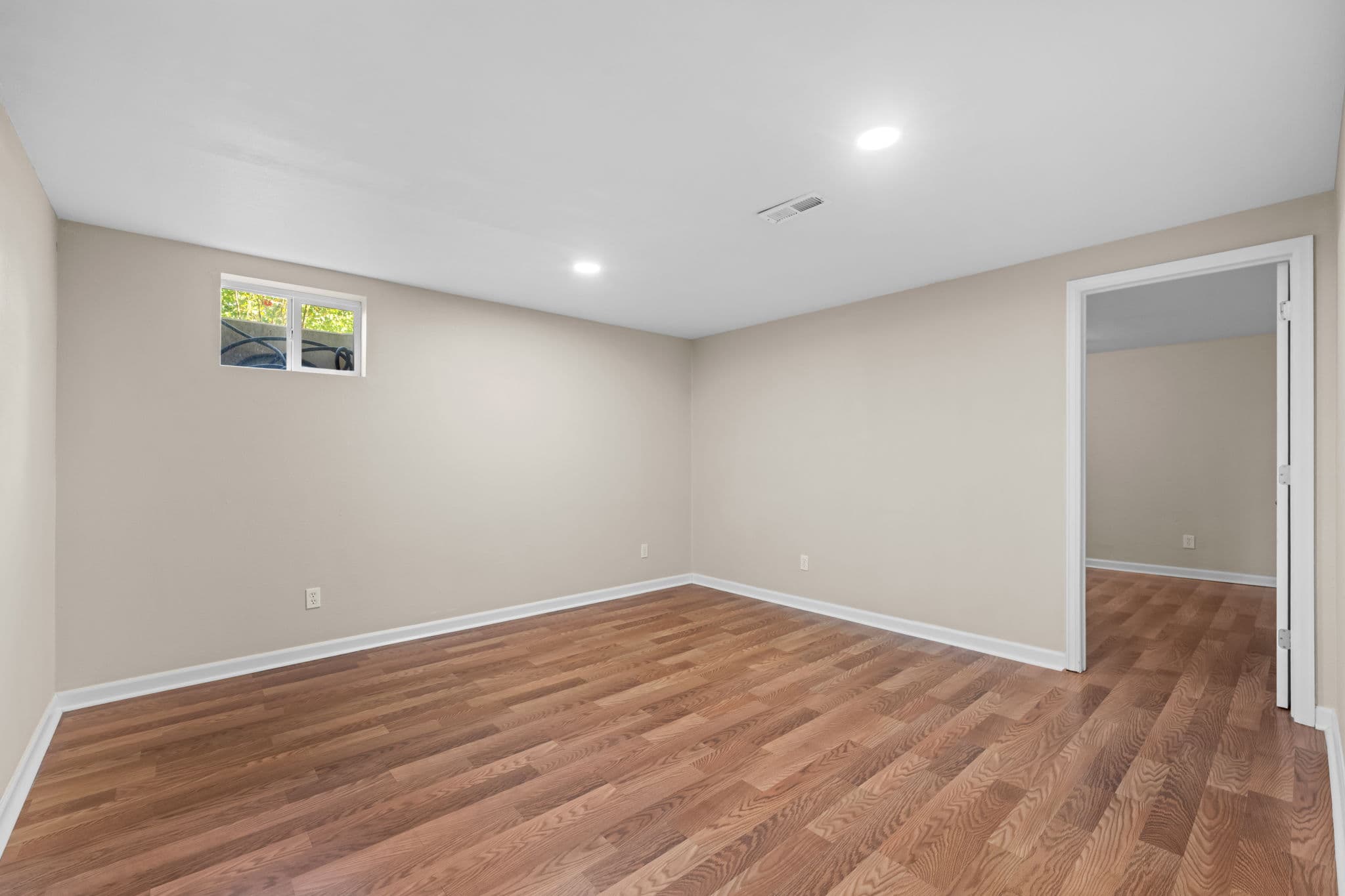 An open lower-level room suited to shared workspace