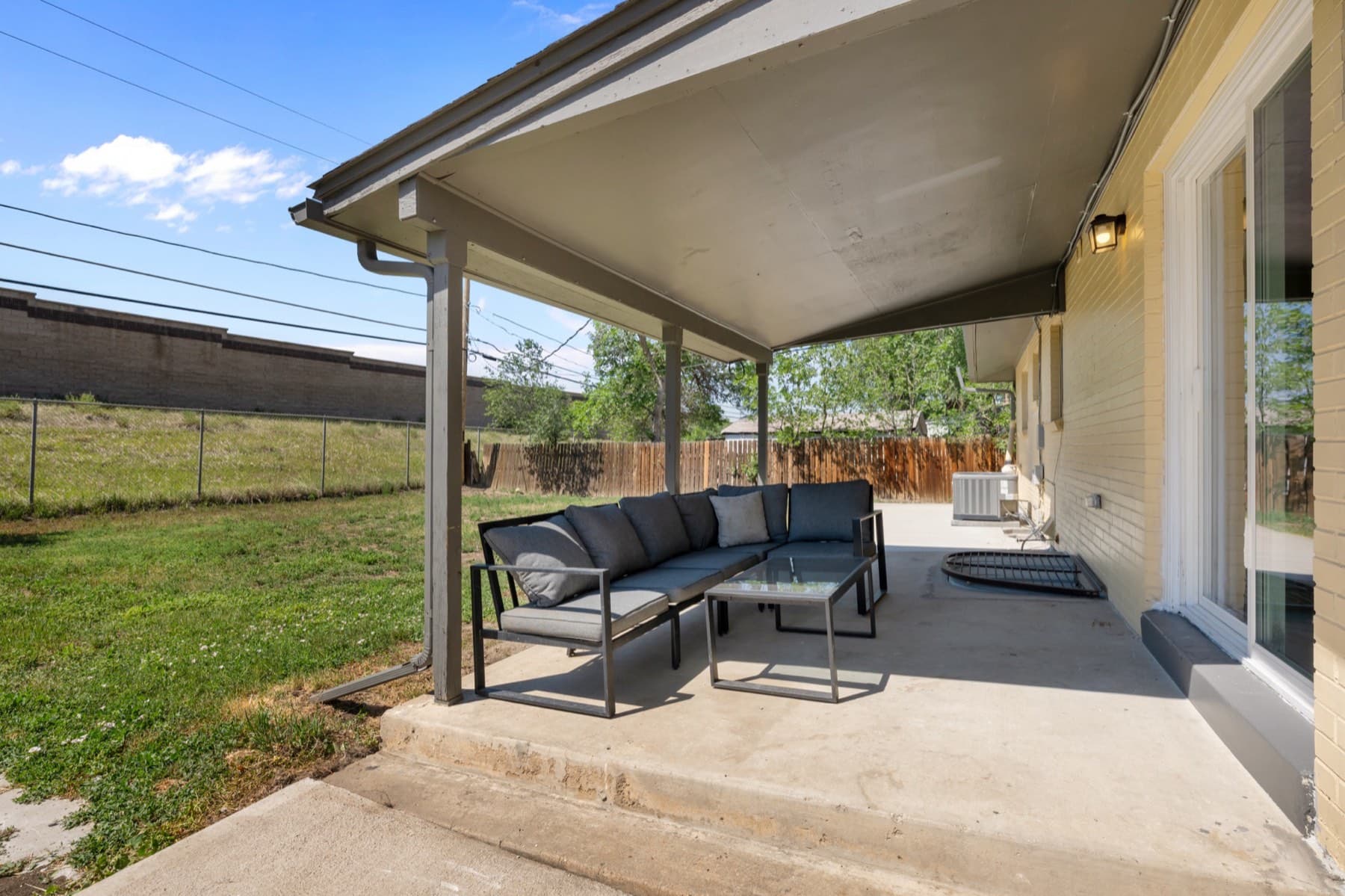 The covered patio and fenced back yard
